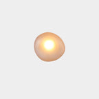 Clérachic Bubble Glass Wall Sconce in amber, squat round shape, with a bright warm centre fading to a honey rim at the edges.