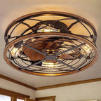 Clérachic caged ceiling fan with light mounted on a room ceiling, wood-look blades and glowing filament bulbs inside a bronze cage.