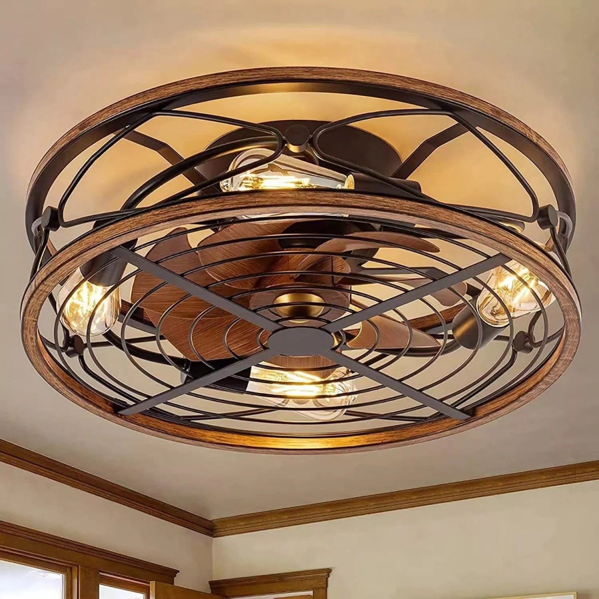 Clérachic caged ceiling fan with light mounted on a room ceiling, wood-look blades and glowing filament bulbs inside a bronze cage.