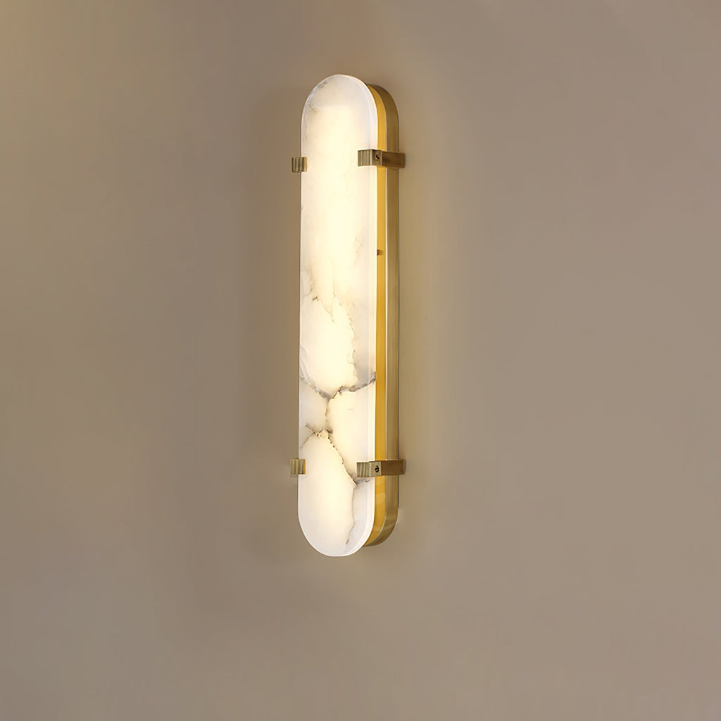 Clérachic Calla wall light in the taller size, brass straps crossing veined alabaster.