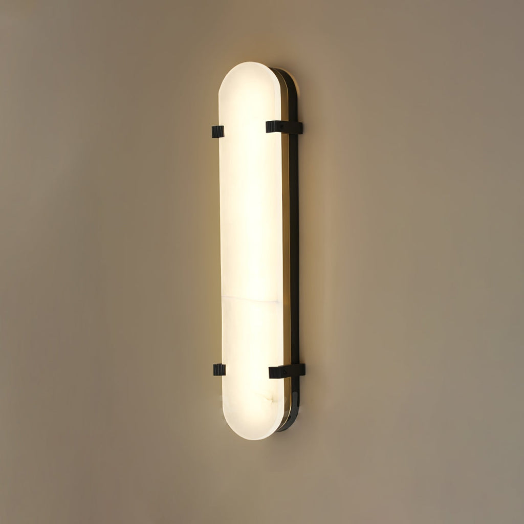 Clérachic Calla wall light with black straps, long alabaster panel lit from within.