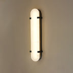 Clérachic Calla wall light with black straps, long alabaster panel lit from within.