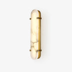 The Clérachic Calla wall light on white, unlit, showing brass hardware against pale stone.