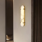 Clérachic Calla wall light on a bedroom wall beside heavy curtains and a full-length mirror.