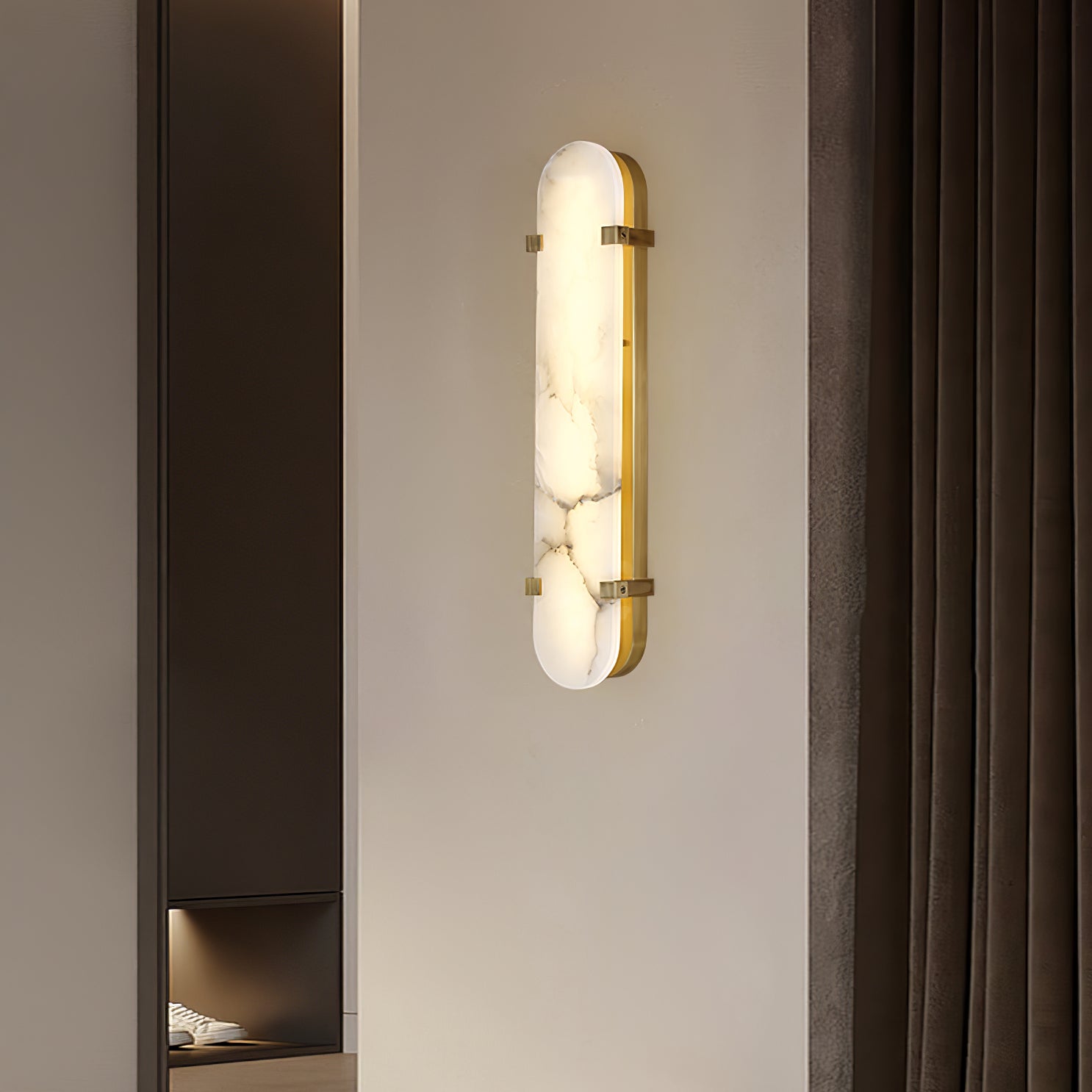 Clérachic Calla wall light on a bedroom wall beside heavy curtains and a full-length mirror.