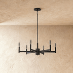 Clérachic six-arm black chandelier shown with the bulbs switched off, clear tubular lamps on square tubes, beneath a plaster ceiling.