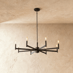 Clérachic wider eight-arm chandelier in matte black with warm filament bulbs on straight bars, on a rod and round canopy.