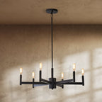 Clérachic six-arm matte black chandelier with lit filament bulbs, window light and shadows falling across a plaster wall.