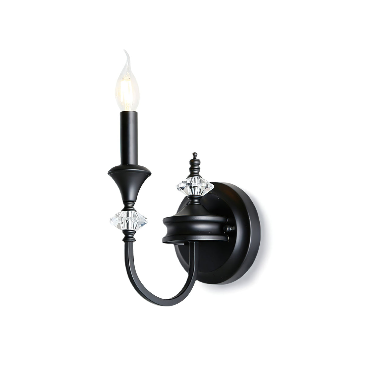 Black single-arm Clérachic wall light on a white backdrop, its candle bulb lit above a curved arm and crystal accents.