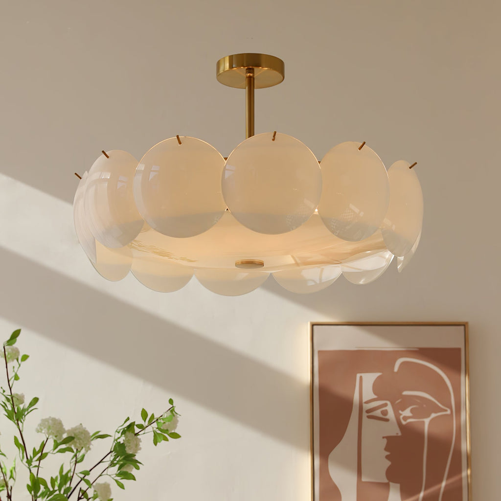 Semi-flush version of this Clérachic chandelier, its overlapping pale shades catching sunlight beside a framed abstract print and a leafy branch.
