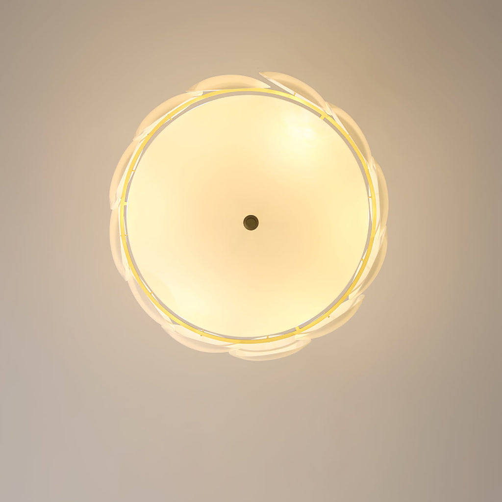 View from directly below of this Clérachic chandelier lit, a warm glow behind the scalloped ring of white shell shades.