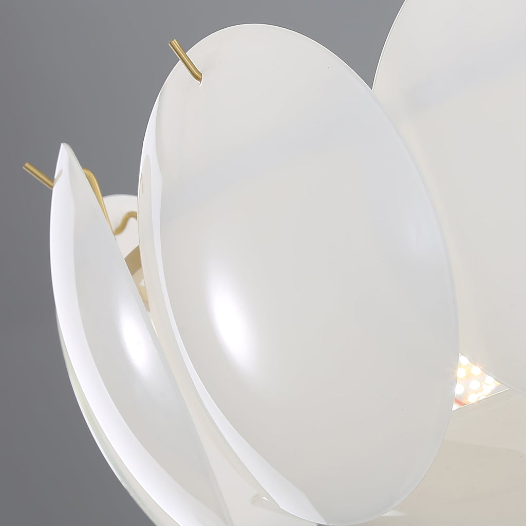 Close view of two curved shell shades held by slim brass pins on this Clérachic chandelier, with a soft light behind.