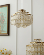 Unlit in daylight, this Clérachic chandelier shows pearly capiz shell teardrops in gold wire frames, with a second fitting below it.