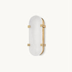 A Clérachic wall light on a plain white backdrop, with an oval alabaster shade held by four aged brass clips on a slim brass backplate.