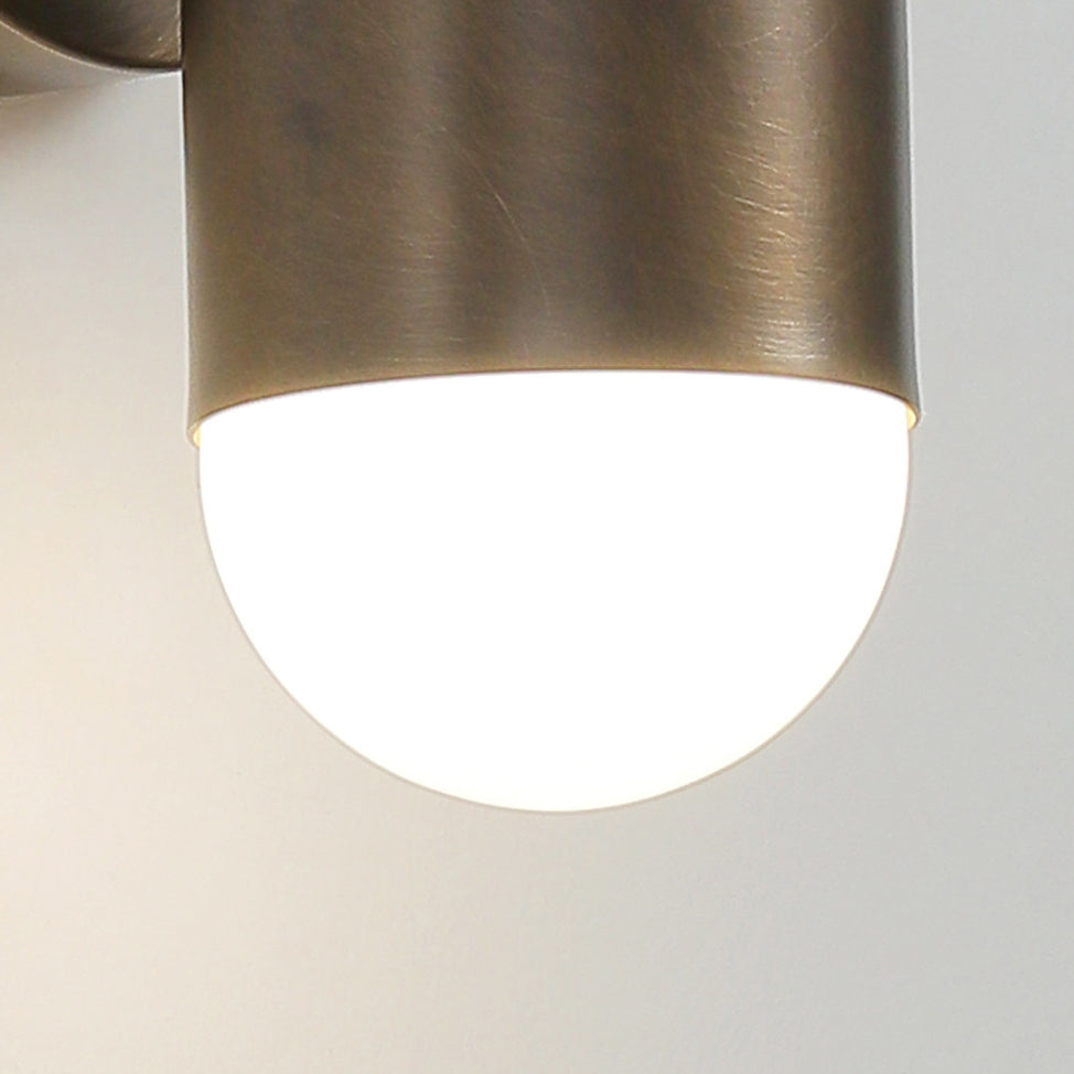 Close view of the frosted glass end and brushed brass rim of this Clérachic wall light.