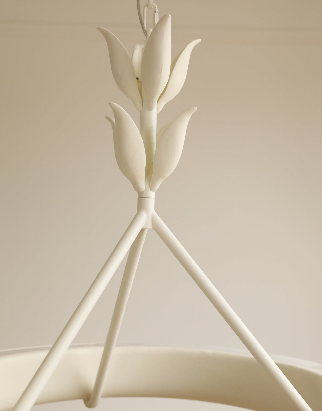 Close view of the layered plaster leaf buds where the three support rods meet, on this Clérachic chandelier.