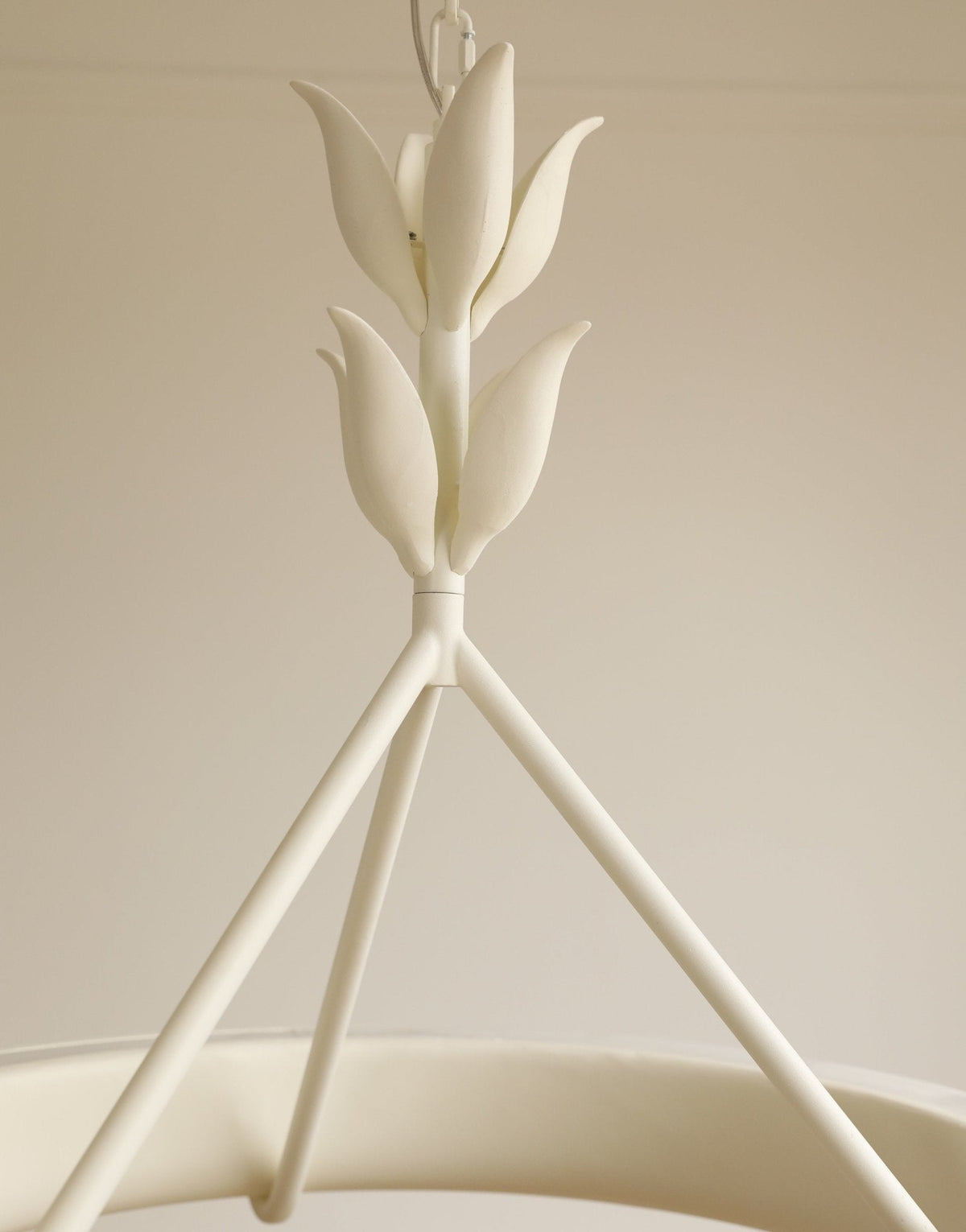 Close view of the layered plaster leaf buds where the three support rods meet, on this Clérachic chandelier.