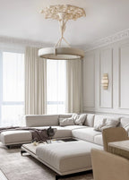Tall living room with cream curtains and a pale corner sofa, where this Clérachic chandelier hangs low from a carved plaster ceiling rose.