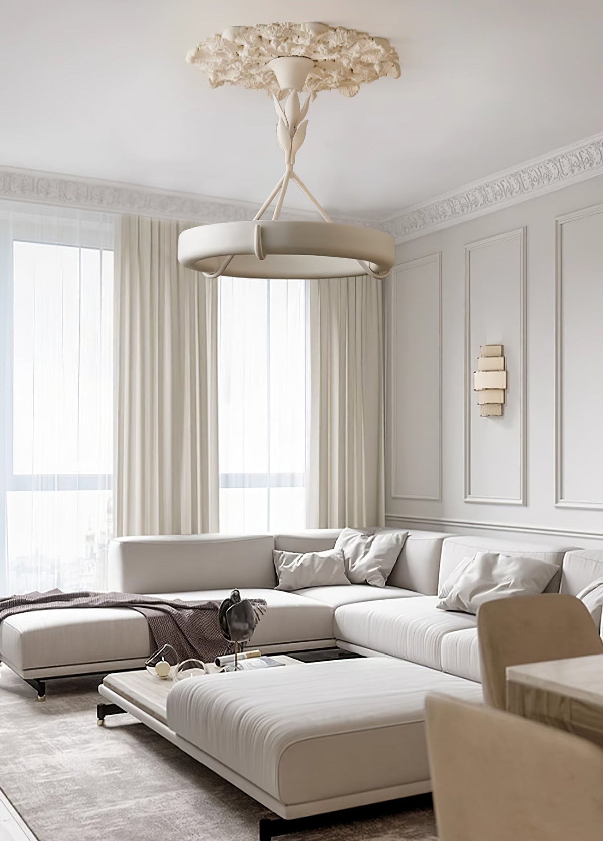 Tall living room with cream curtains and a pale corner sofa, where this Clérachic chandelier hangs low from a carved plaster ceiling rose.