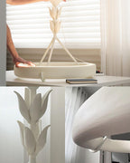 Three views in one: the white ring on a table, a close-up of the leaf buds, and the curved rim detail of this Clérachic chandelier.