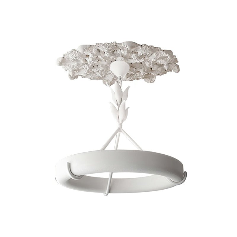 Chandelier with its carved plaster ceiling rose attached above the cap, shown on a white studio backdrop; a Clérachic ceiling light.