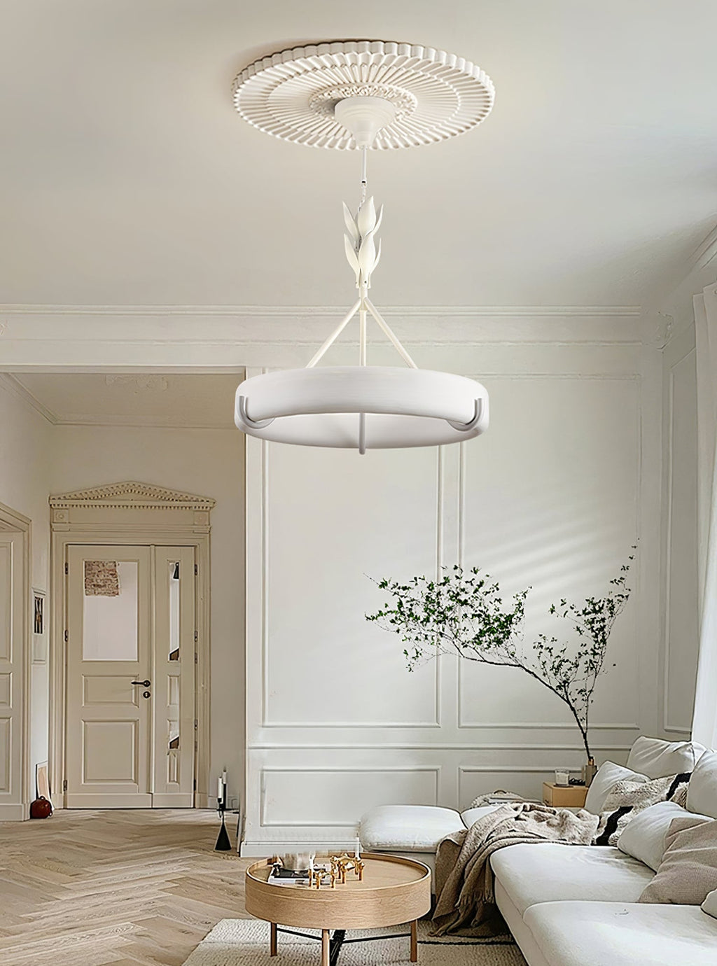 Bright hallway-style living room with a herringbone floor and a leafy plant, with this Clérachic chandelier hanging below a ribbed rose.