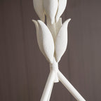 Close view of the grainy plaster leaf buds on this Clérachic chandelier, where they join the three white rods.