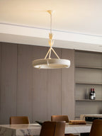 Three-quarter view of the white ring with open shelves and a wine bottle behind it; a Clérachic chandelier.