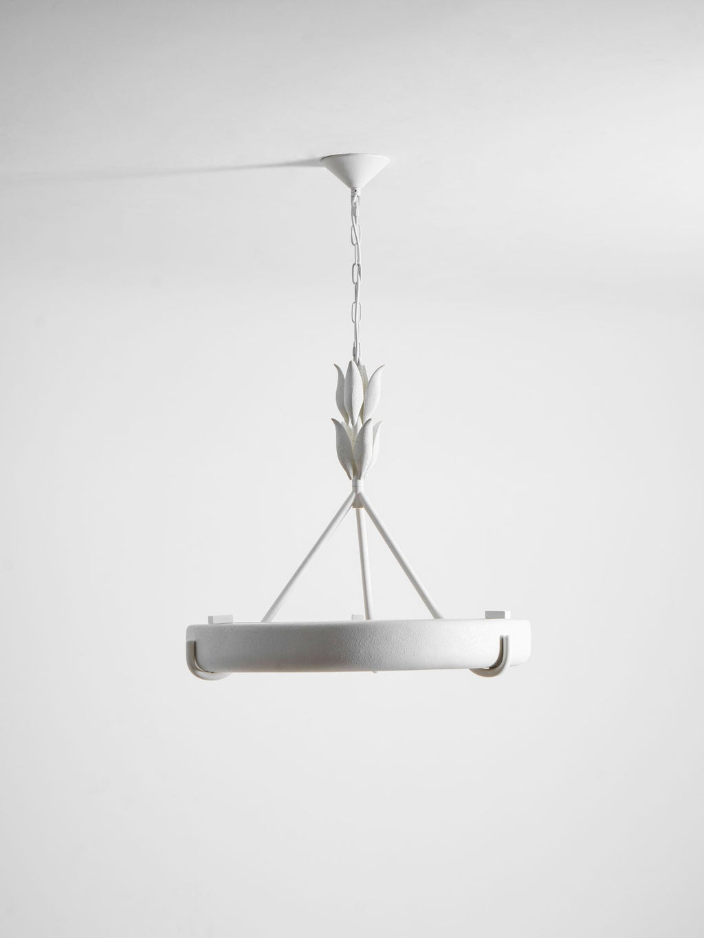 Straight-on studio shot of the white ring on its chain, with the leaf buds and three rods above; a Clérachic chandelier.
