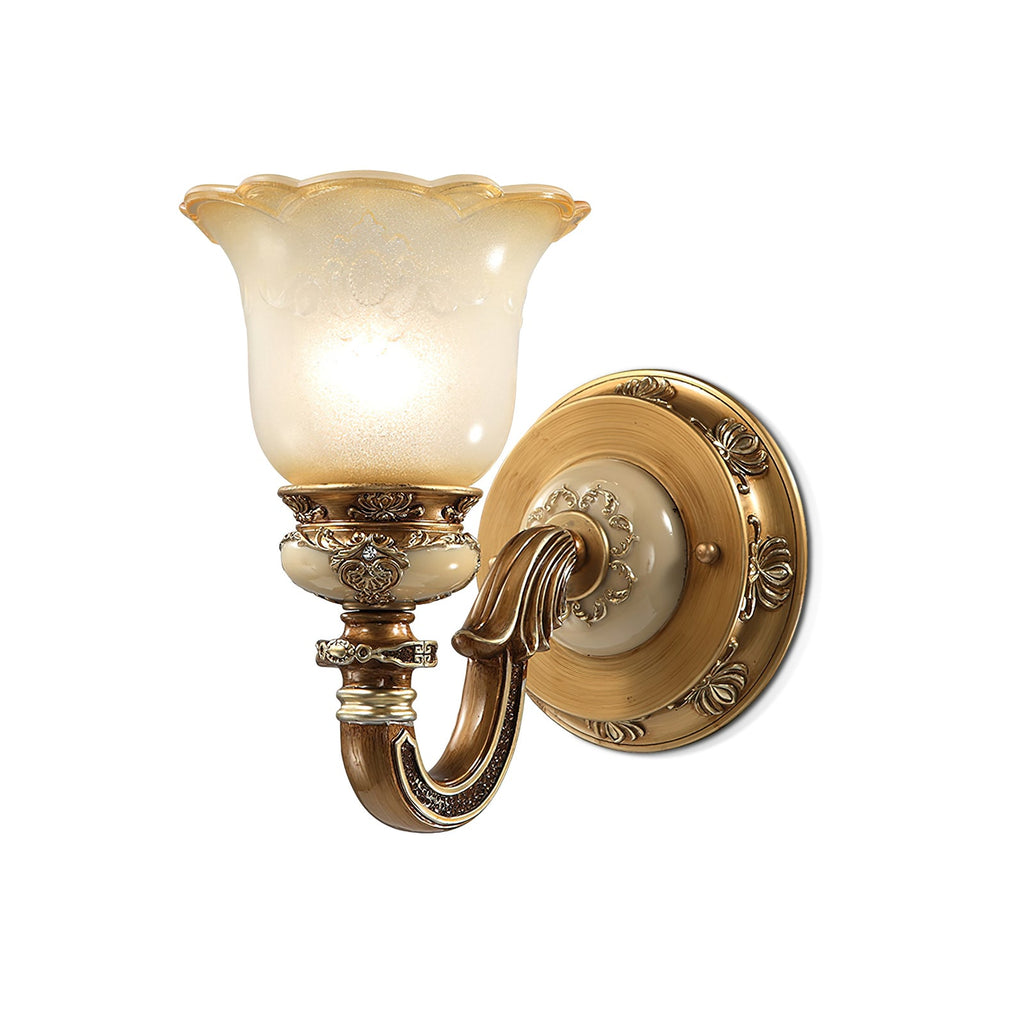 Single-head Clérachic wall light on a white backdrop, its bell-shaped glass shade glowing above a detailed bronze and gold arm.
