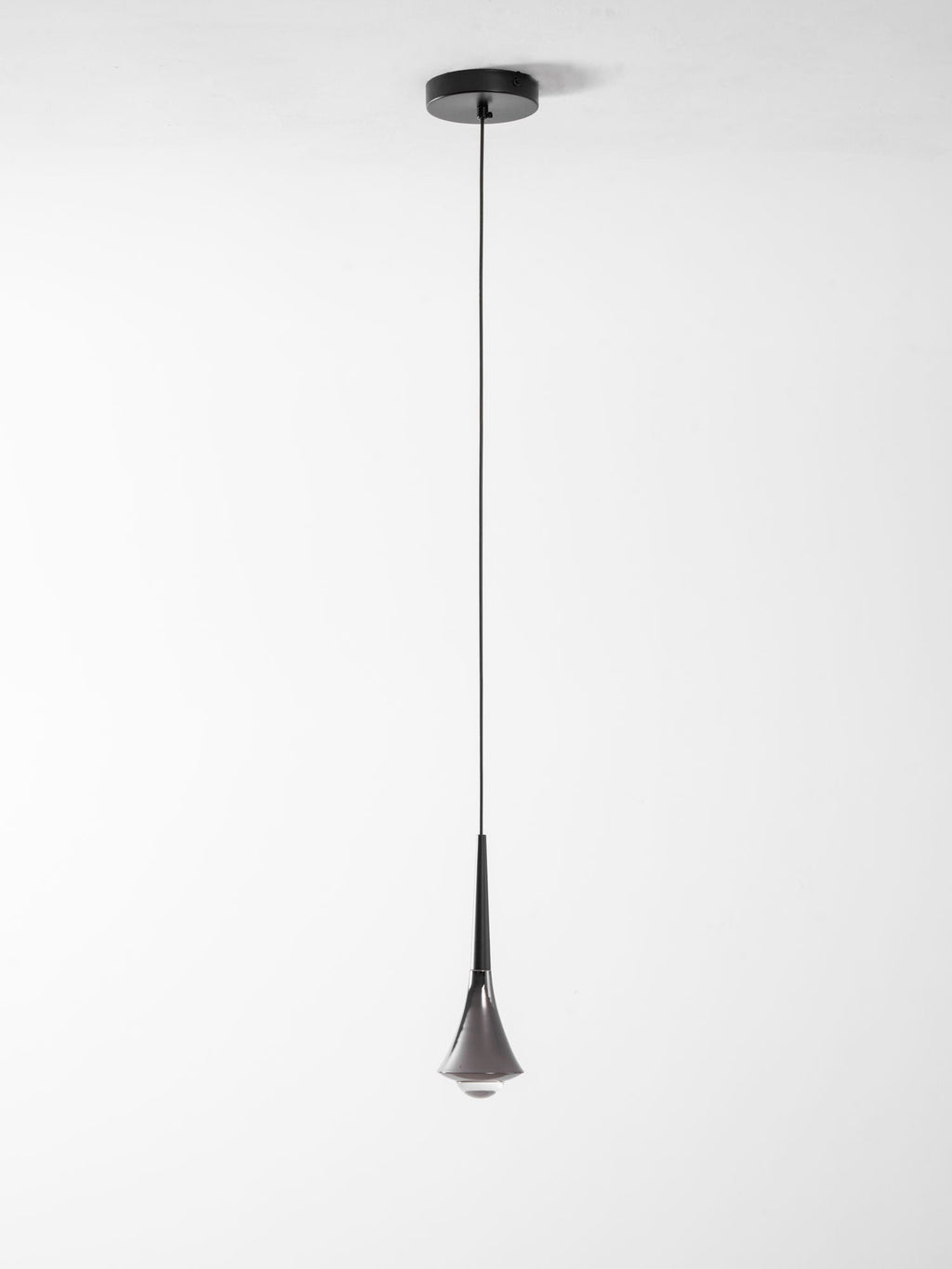 Full length of a Clérachic pendant on a thin black cord from a small black ceiling plate, shown on a pale background.