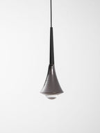 Clérachic pendant with a black neck and a flared chrome body, with a clear glass base seen from slightly below.