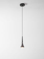 A Clérachic pendant on a long thin cord from a small black canopy, with a lit opal bulb at the tip, on a pale backdrop.