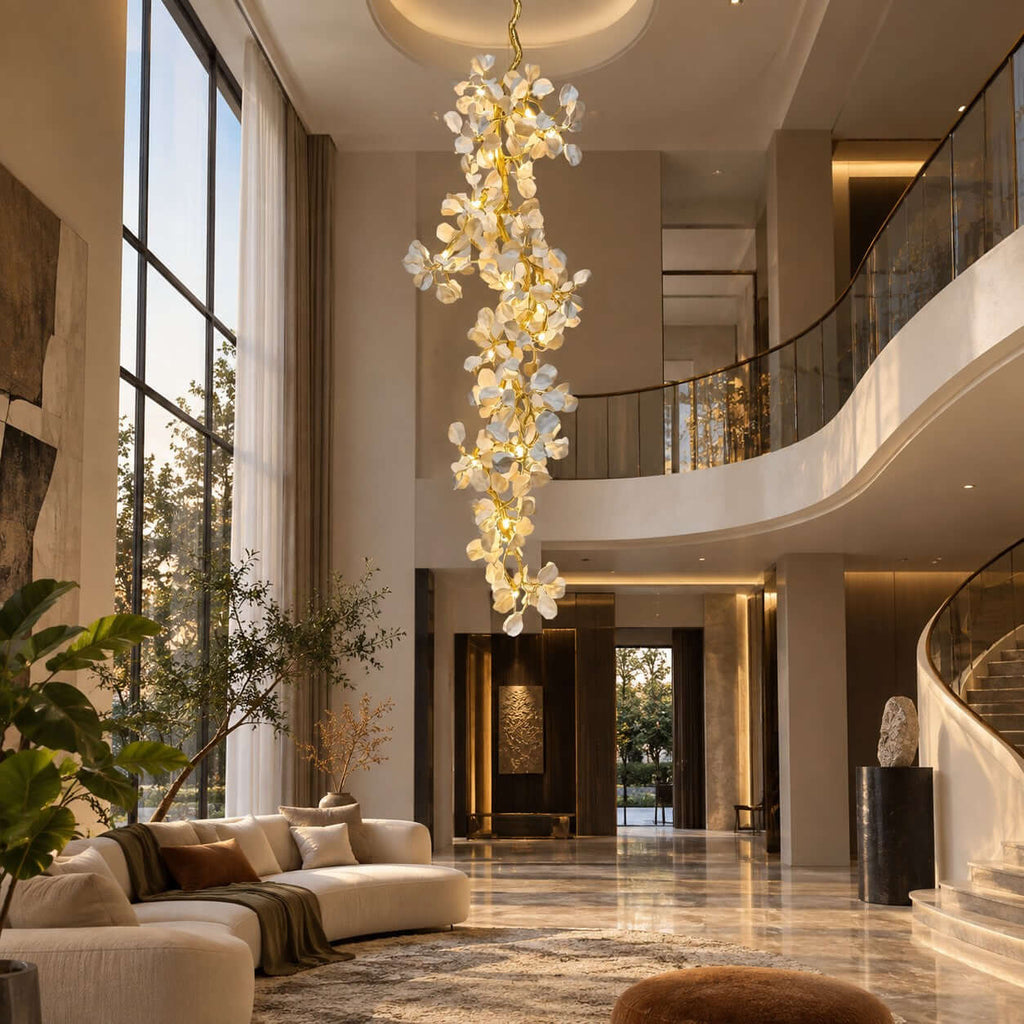 Clérachic chandelier of layered ceramic petals hung in front of a curved balcony and a marble floor with a sofa in the corner.