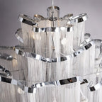 Clérachic silver chandelier close up, showing the polished curved ribbon rims and layers of fine hanging chain.
