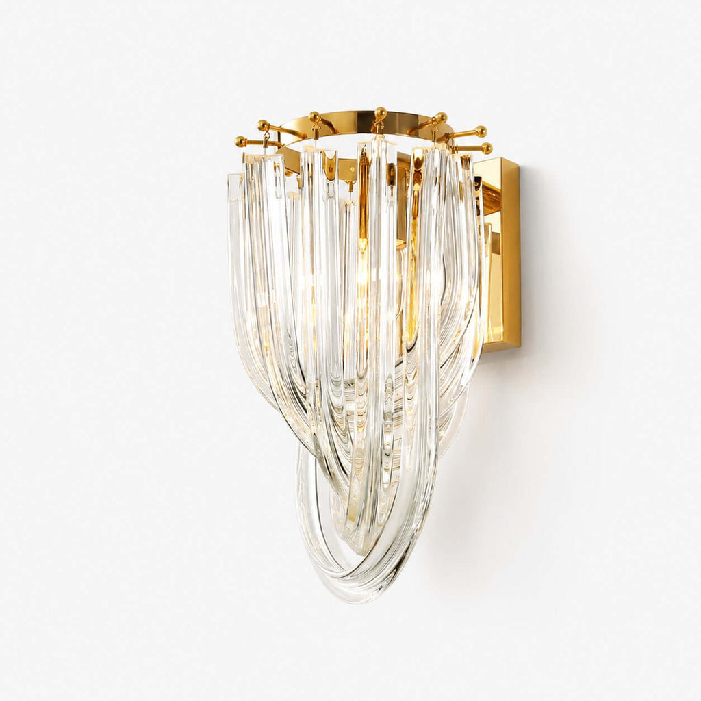 A Clérachic wall light with cascading clear glass strands looped over a gold backplate, on a plain white backdrop.