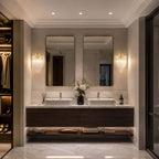 Two Clérachic wall lights sit either side of twin mirrors over a double vanity, in a bathroom with a walk-in wardrobe.