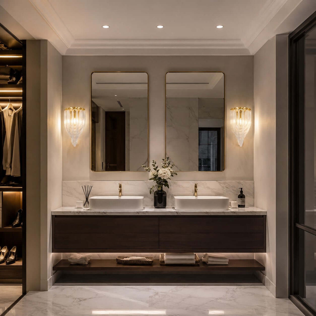 Two Clérachic wall lights sit either side of twin mirrors over a double vanity, in a bathroom with a walk-in wardrobe.