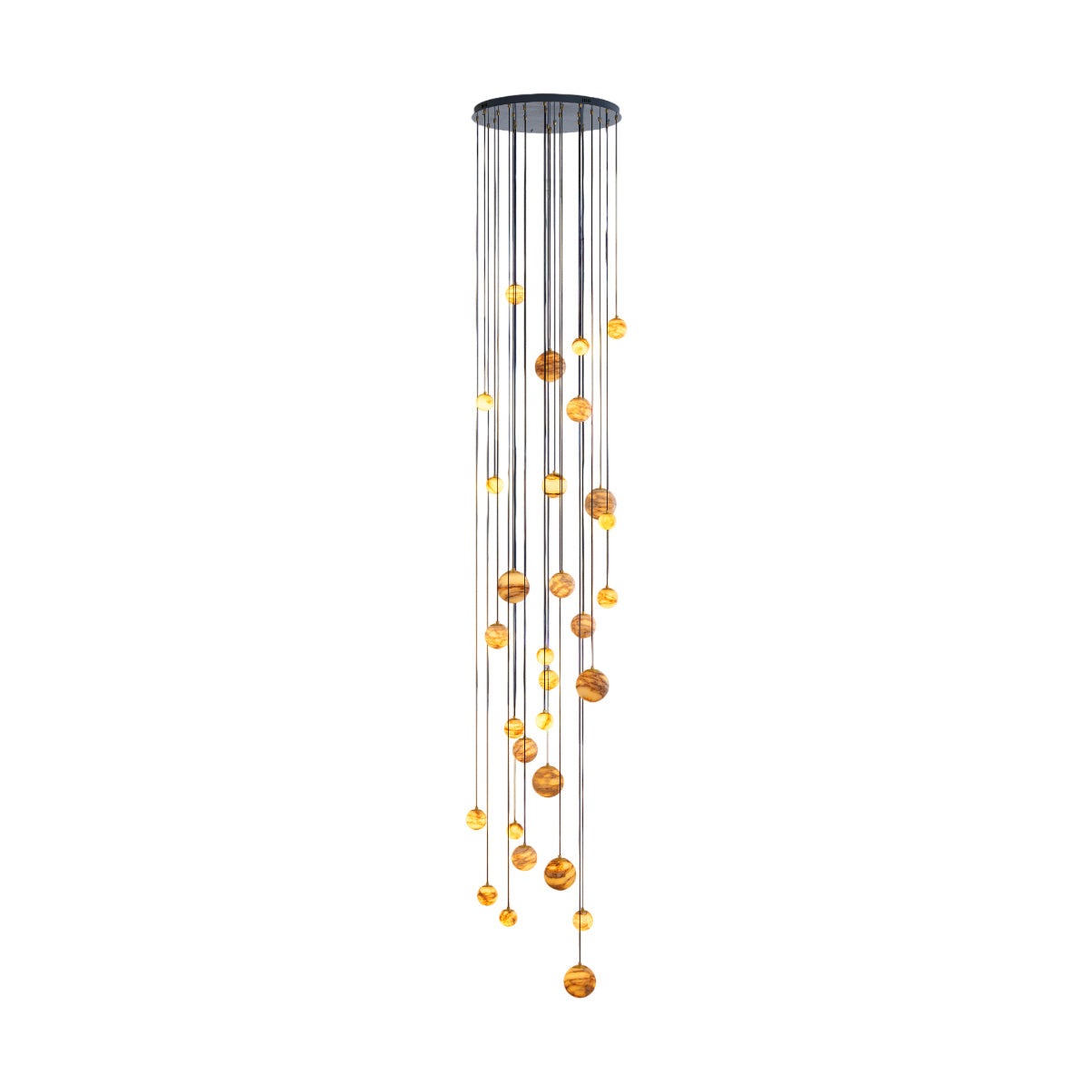The Clérachic Cascading Globe Chandelier lit against white, honey-amber spheres falling from a matte black canopy in a tall spiral.