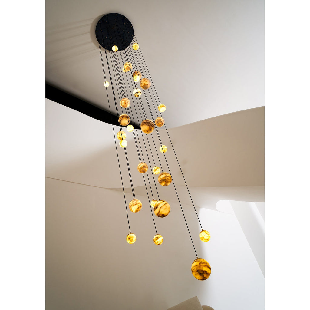 Looking up at the matte black canopy of the Clérachic Cascading Globe Chandelier, every cord leaving its own point across the disc.