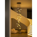 At night the Clérachic Cascading Globe Chandelier lights the stairwell alone, its spheres casting warm amber across the curved wall.