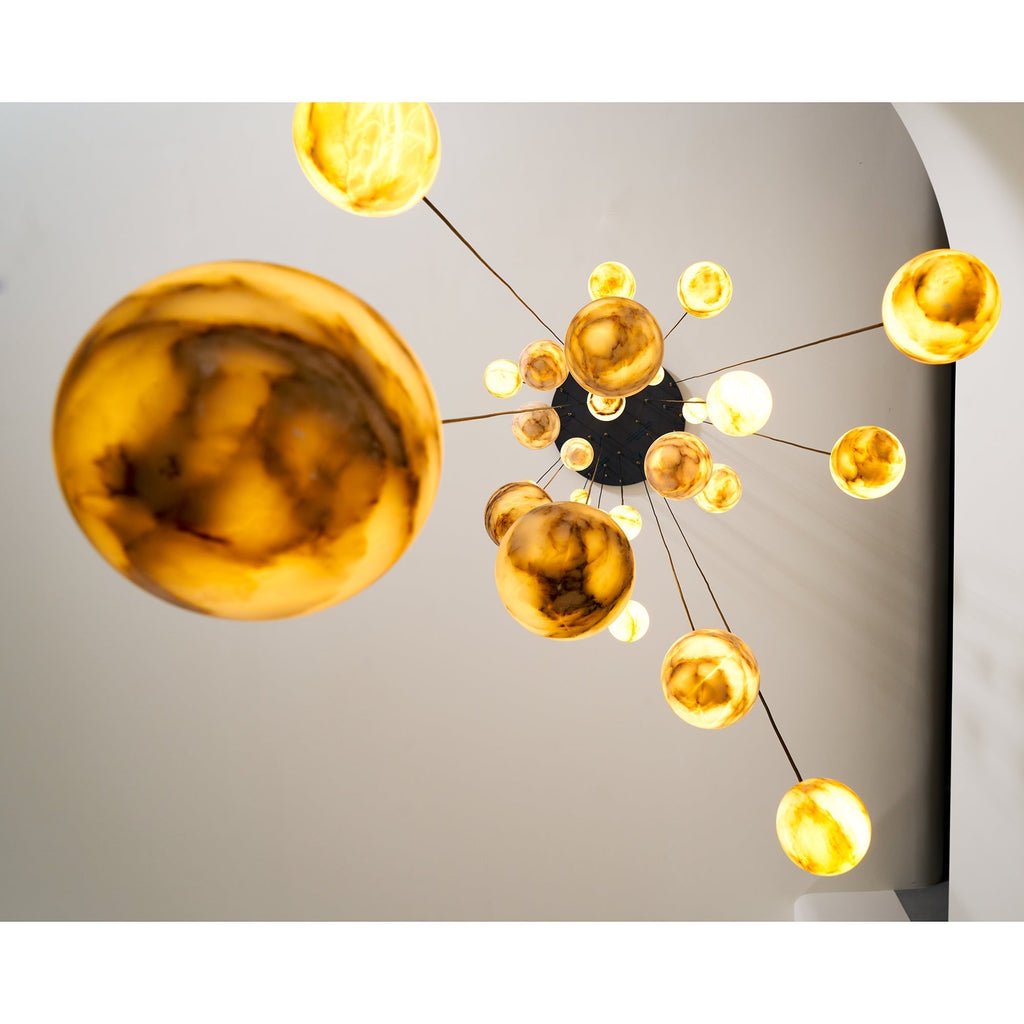 From directly beneath, the Clérachic Cascading Globe Chandelier fans out from its canopy, one lit sphere filling the near foreground.