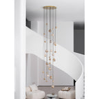The Clérachic Cascading Globe Chandelier with a gold canopy, unlit by day, the alabaster reading warm off-white banded with tan.