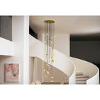 Room view of the Clérachic Cascading Globe Chandelier filling the double-height space between a spiral stair and a framed canvas.
