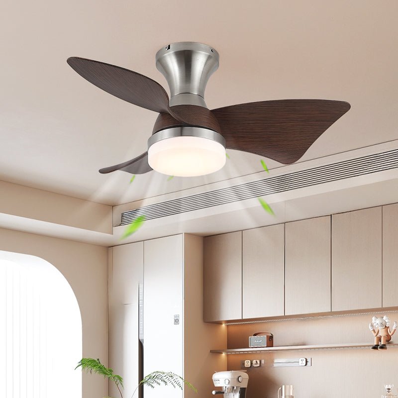 A Clérachic nickel ceiling fan with walnut-grain blades and a lit round light, with green arrows showing air moving down in a modern kitchen.