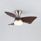 A Clérachic ceiling fan in nickel with walnut-grain blades and a warm light, seen at a slight angle from below on grey.