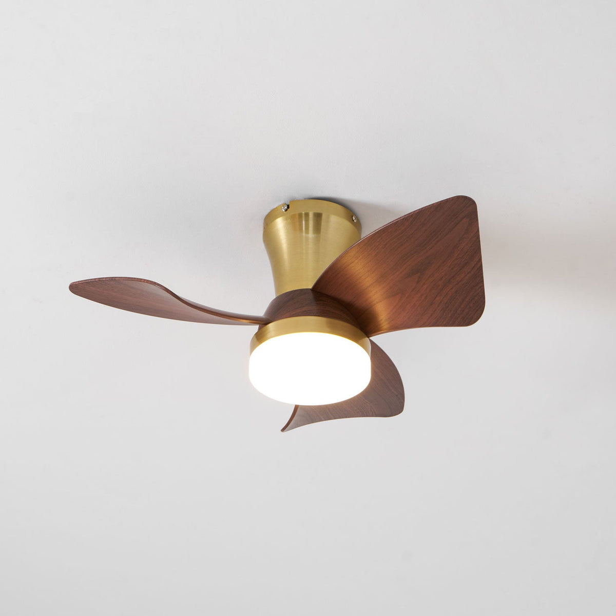 The Clérachic gold ceiling fan from a different angle, with its three blades and bright round light under the brass-toned canopy.