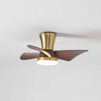 A Clérachic gold ceiling fan with its light on, the blades seen slightly blurred as they turn against a pale ceiling.