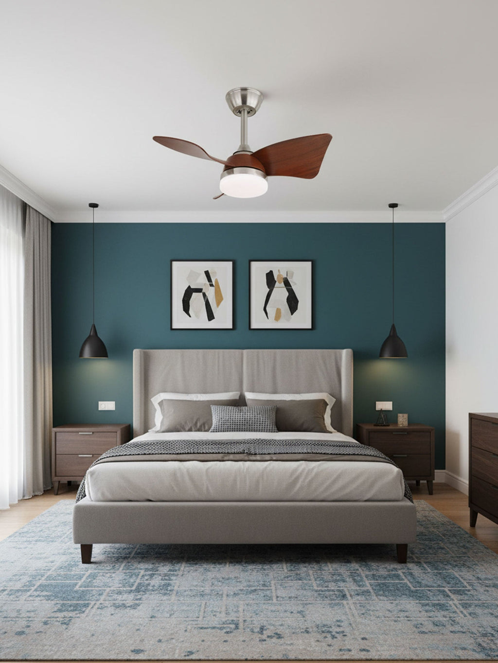 A small Clérachic fan with curved walnut blades hangs above a bed with a tall grey headboard and a teal accent wall.