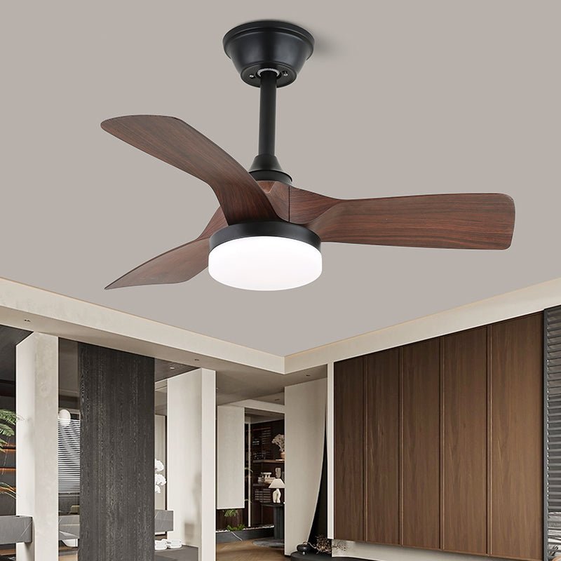 Close view from below of this Clérachic fan, with three wide walnut blades, a black stem and a lit round white light.